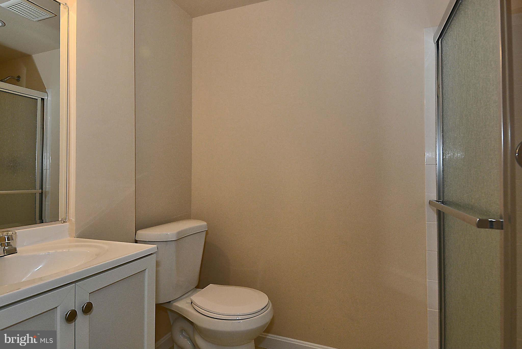 11457 Encore Drive Silver Spring, MD 20901 - Photo 20 of 27 a white toilet sitting next to a bathroom sink