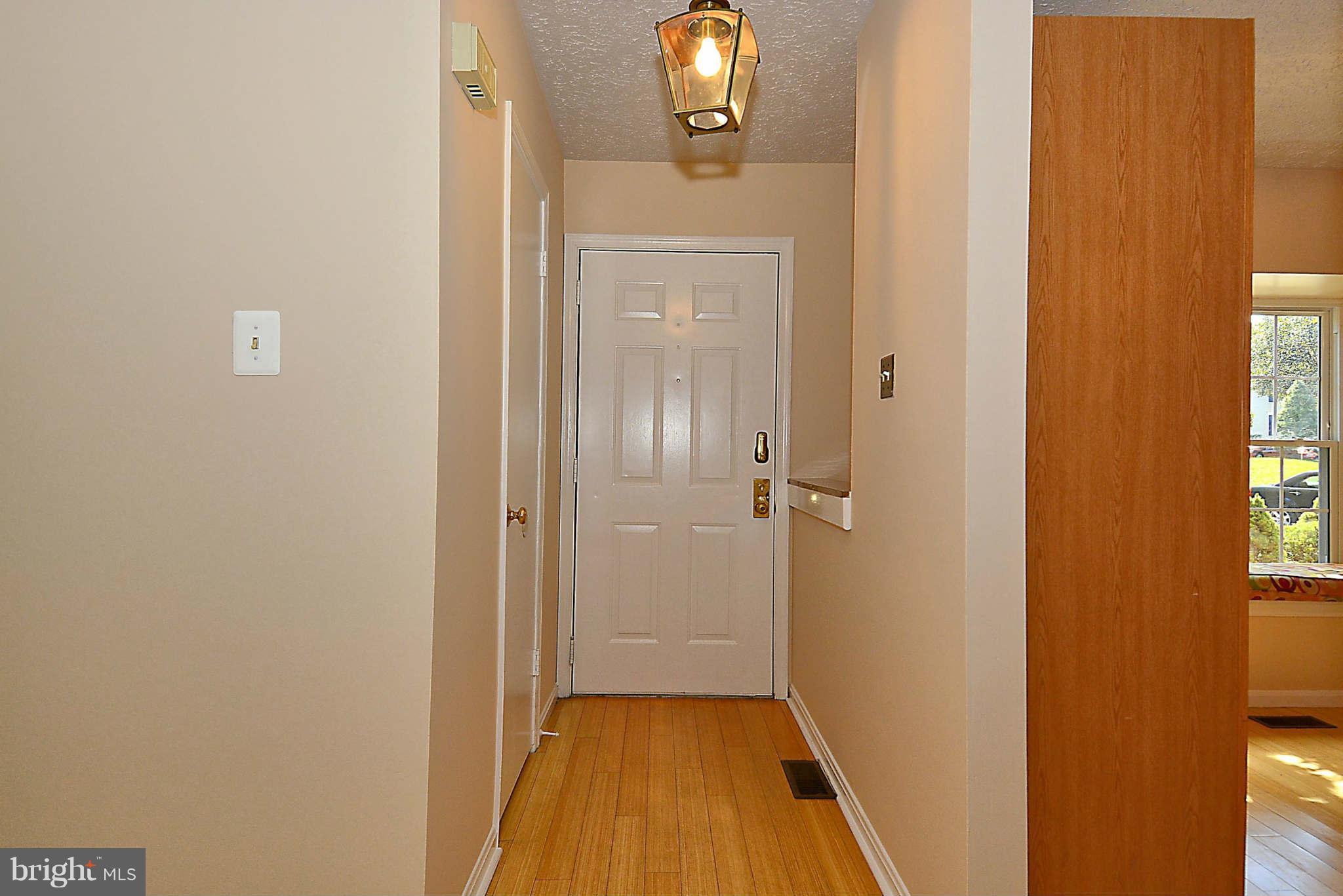 11457 Encore Drive Silver Spring, MD 20901 - Photo 3 of 27 a view of a hallway with wooden floor