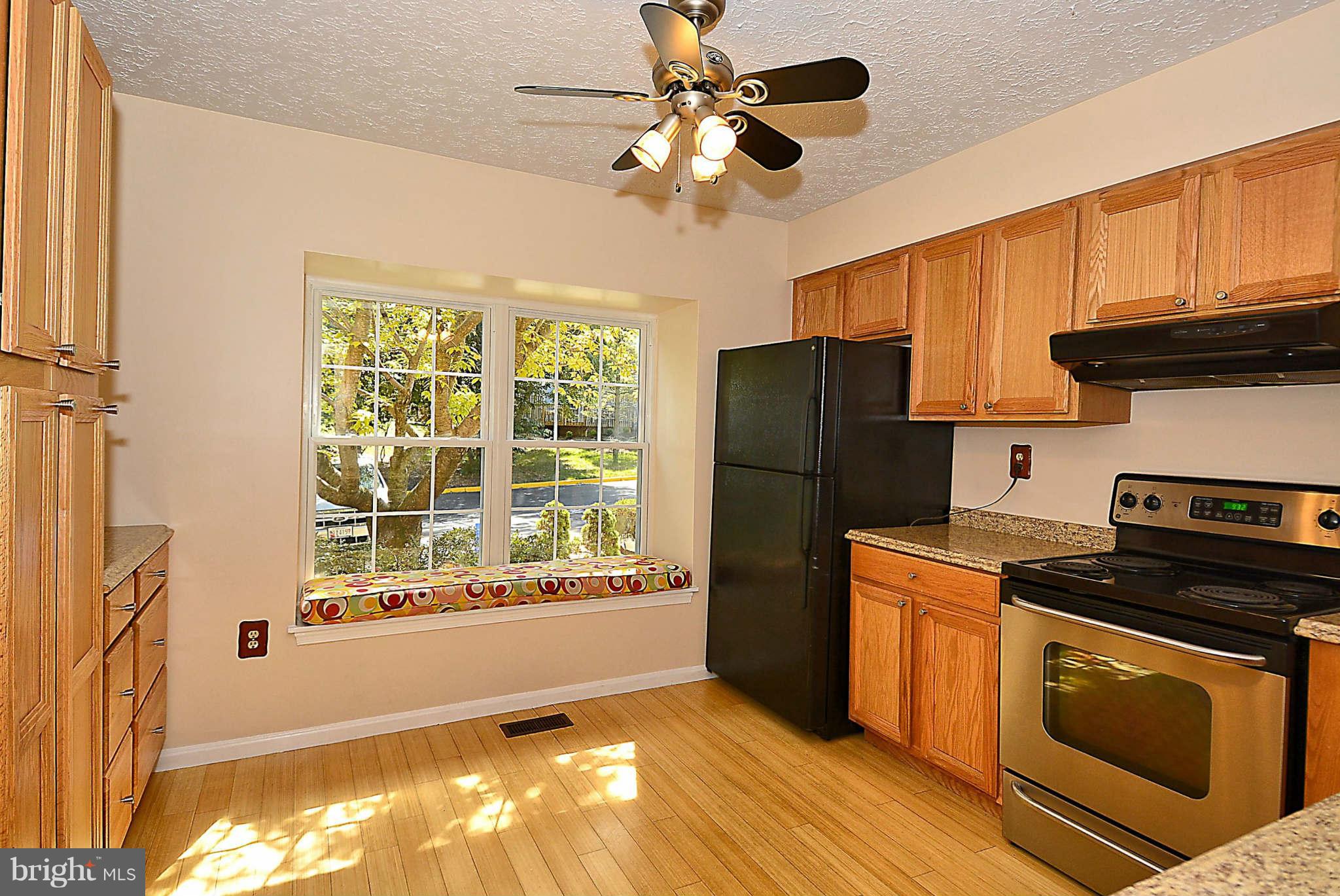 11457 Encore Drive Silver Spring, MD 20901 - Photo 4 of 27 a kitchen with stainless steel appliances granite countertop a refrigerator a stove a sink and a microwave