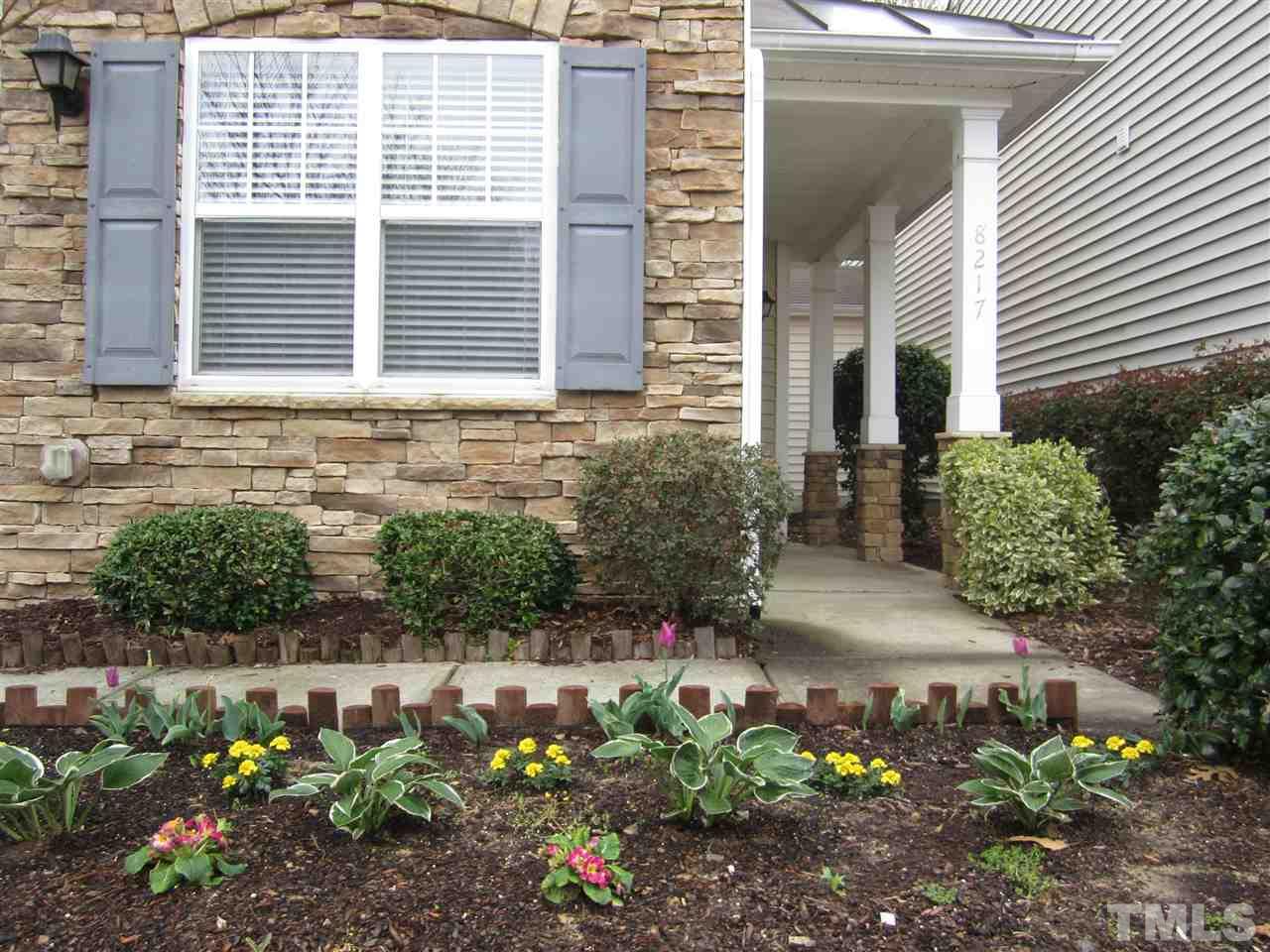 8217 Beaded Stone Street Raleigh, NC 27613 - Photo 2 of 16 a front view of a house with a yard