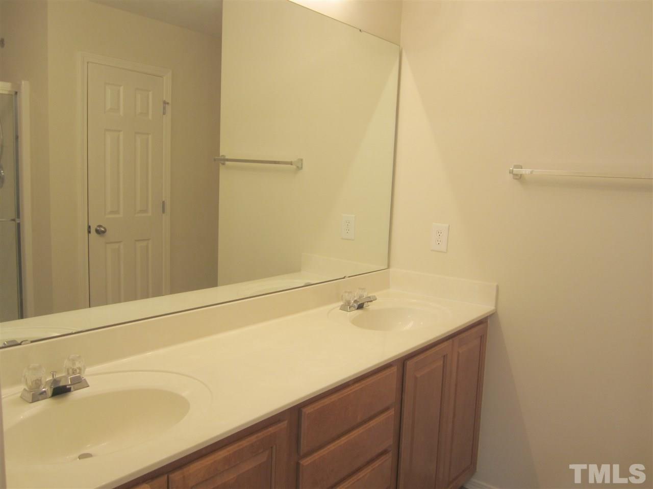 8217 Beaded Stone Street Raleigh, NC 27613 - Photo 12 of 16 a bathroom with a sink and a mirror