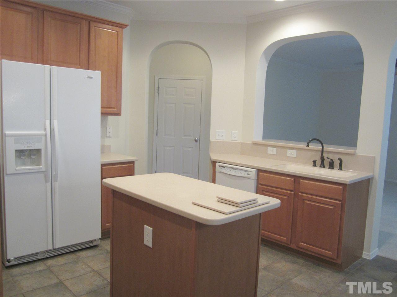 8217 Beaded Stone Street Raleigh, NC 27613 - Photo 7 of 16 a utility room with sink a washer and dryer