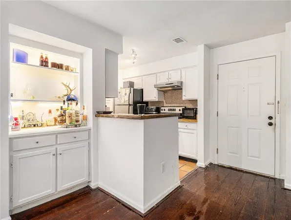 a kitchen with stainless steel appliances a refrigerator sink and microwave