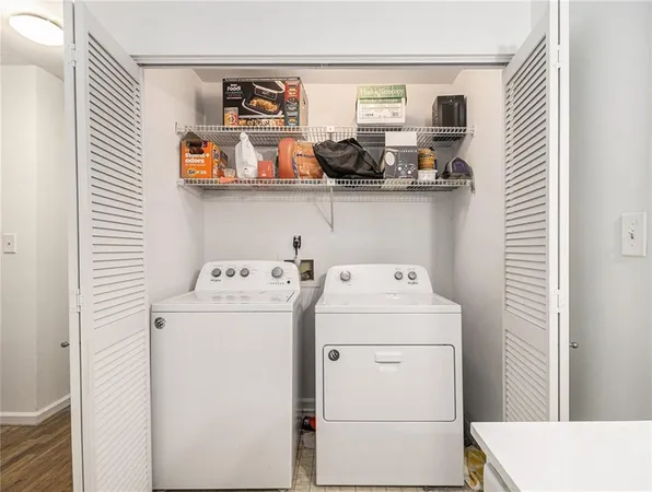 a view of storage and utility room with washer and dryer