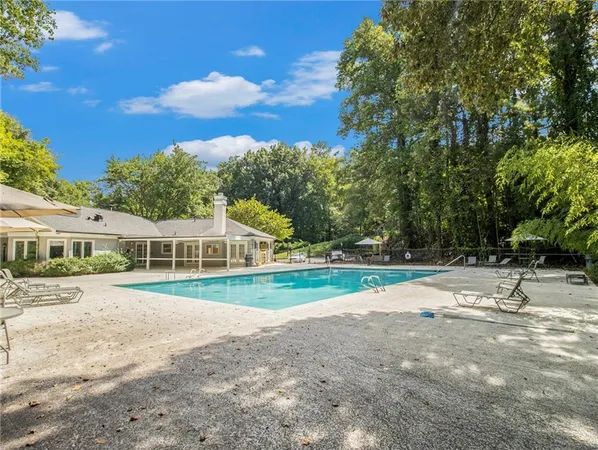 a view of an house with backyard and a tree
