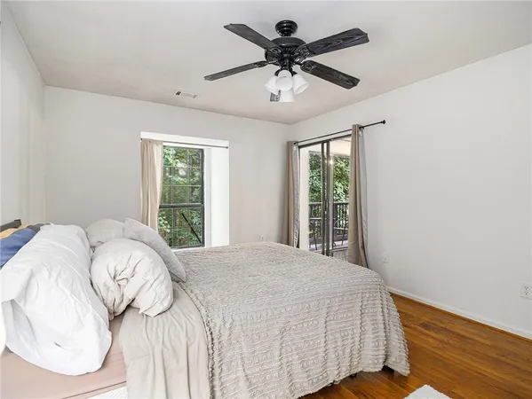 a bedroom with a large bed and a window