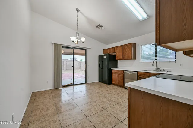 a kitchen with stainless steel appliances a sink and a refrigerator