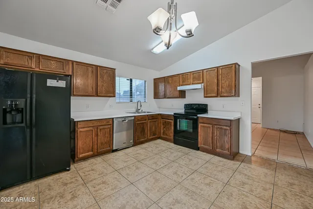 a kitchen with a refrigerator cabinets and wooden floor