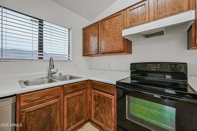 a kitchen with a sink stove and cabinets