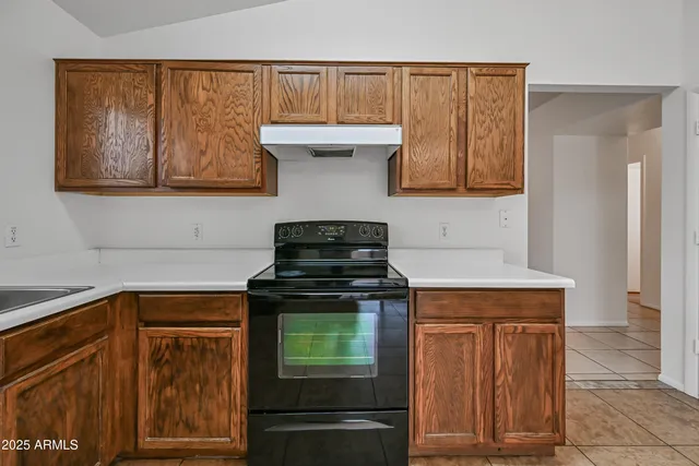 a kitchen with granite countertop cabinets and black appliances