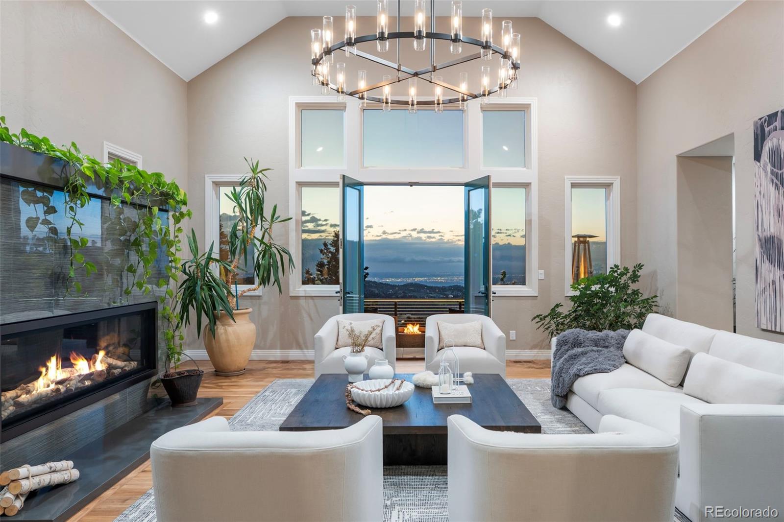 730 Genesee Mountain Road Golden, CO 80401 - Photo 5 of 50 a living room with furniture a fireplace and a chandelier