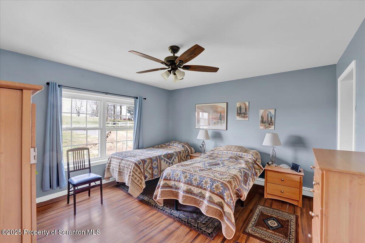 3330 Quicktown Road Moscow, PA 18444 - Photo 12 of 34 a bedroom with a bed and a chandelier