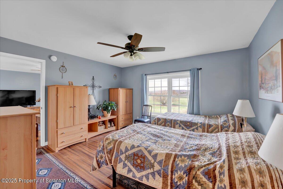 3330 Quicktown Road Moscow, PA 18444 - Photo 13 of 34 a bedroom with a bed and a chandelier