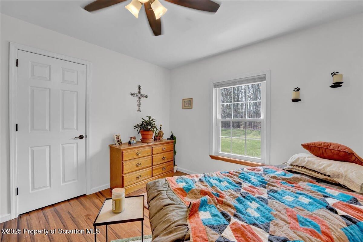 3330 Quicktown Road Moscow, PA 18444 - Photo 17 of 34 a bedroom with a bed and wooden floor