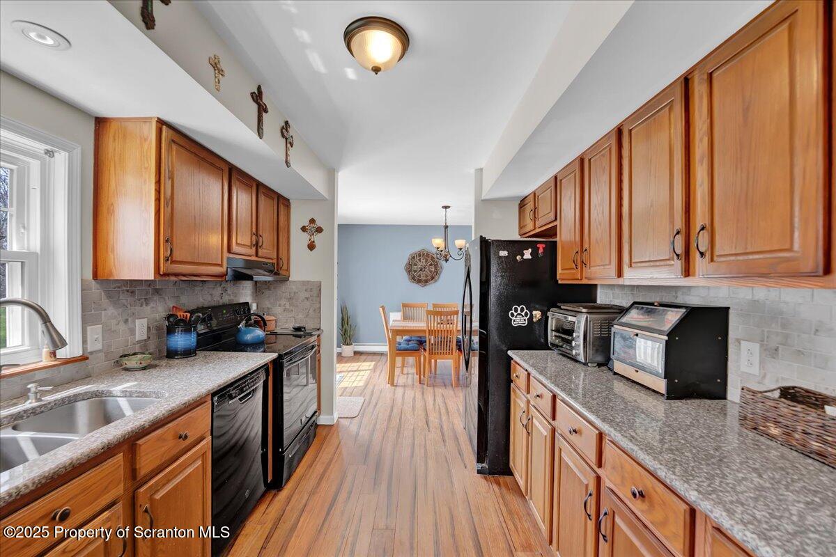 3330 Quicktown Road Moscow, PA 18444 - Photo 3 of 34 a kitchen with stainless steel appliances granite countertop sink stove refrigerator and cabinets
