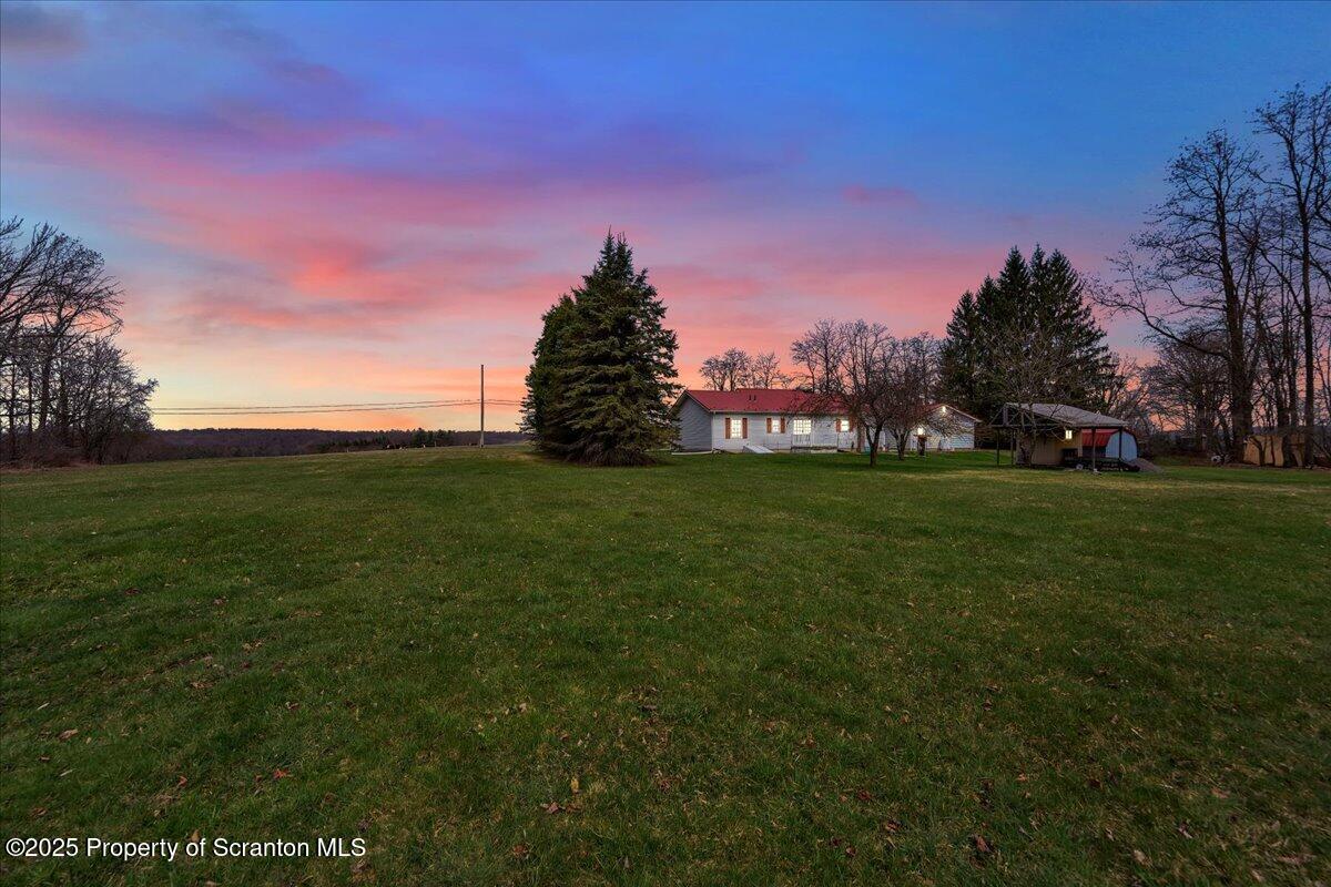 3330 Quicktown Road Moscow, PA 18444 - Photo 32 of 34 a view of a grassy field with trees in the background