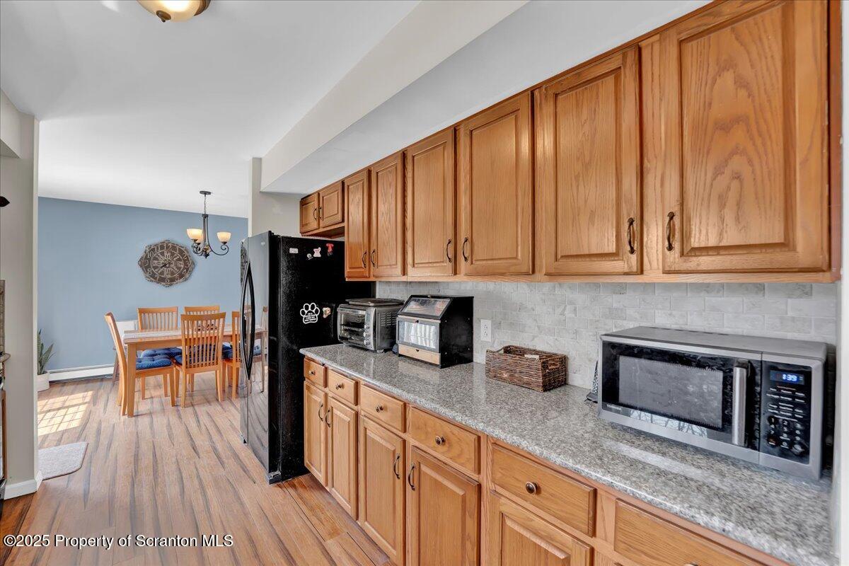 3330 Quicktown Road Moscow, PA 18444 - Photo 4 of 34 a kitchen with stainless steel appliances granite countertop a stove a sink dishwasher and a microwave with wooden floor