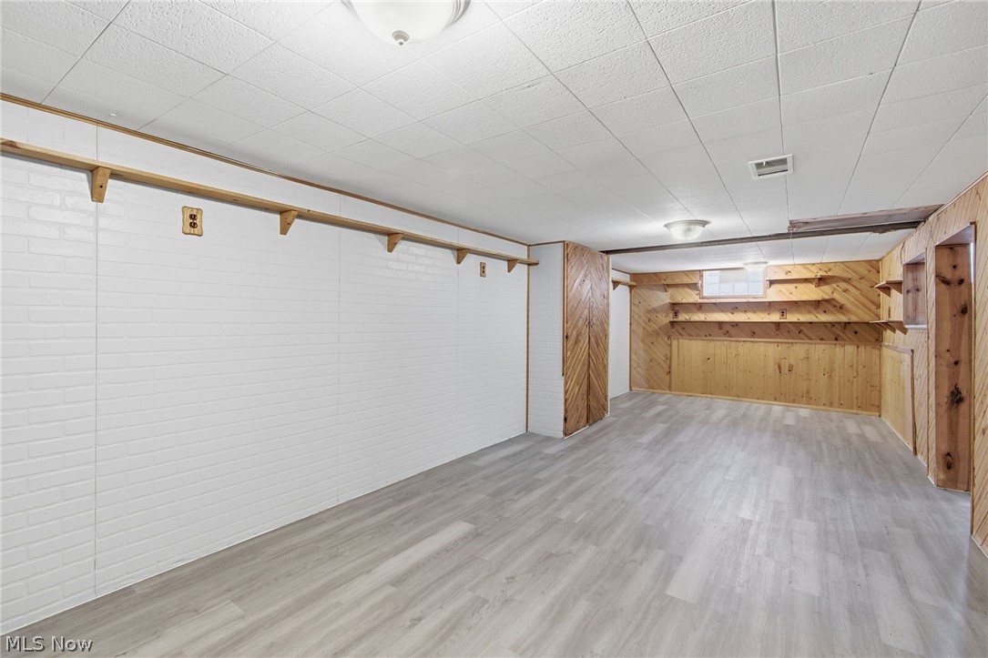20705 Hansen Road Maple Heights, OH 44137 - Photo 23 of 24 Below grade area featuring wooden walls and light wood-type flooring