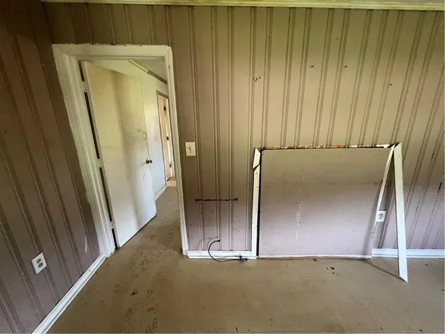 a view of a room with window and hardwood floor