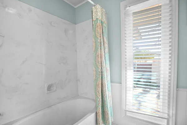 a bedroom with a bed couch and window