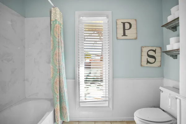 a spacious bathroom with a double vanity sink mirror and toilet