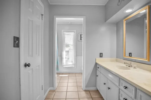 a spacious bathroom with a sink mirror and a shower