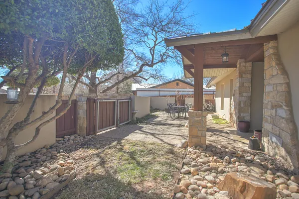 a view of a patio with table and chairs and potted plants
