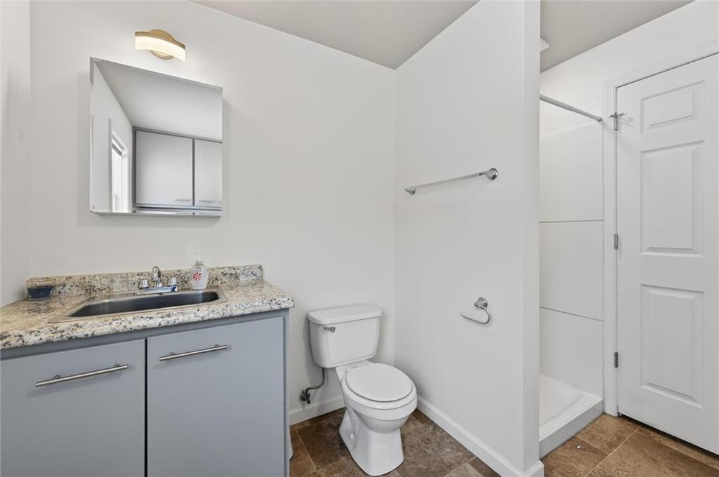 126 West Ranson Avenue Blairsville, PA 15717 - Photo 13 of 27 a bathroom with a granite countertop sink toilet and mirror