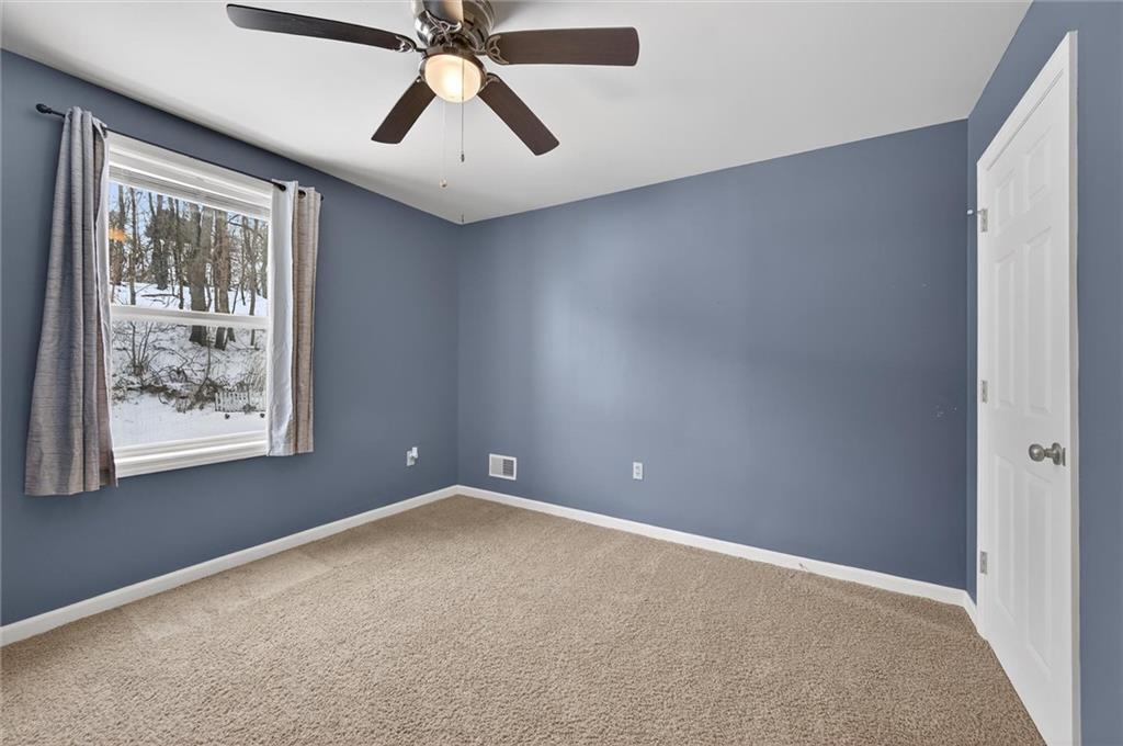 126 West Ranson Avenue Blairsville, PA 15717 - Photo 19 of 27 an empty room with chandelier fan and windows