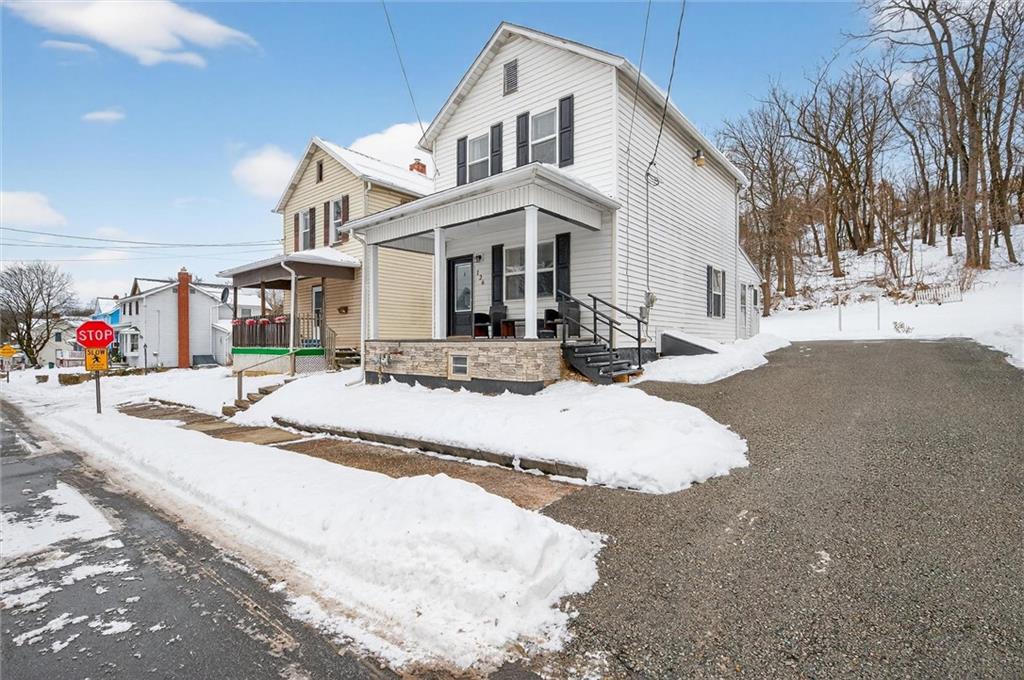 126 West Ranson Avenue Blairsville, PA 15717 - Photo 4 of 27 a view of a white house with a yard covered in snow
