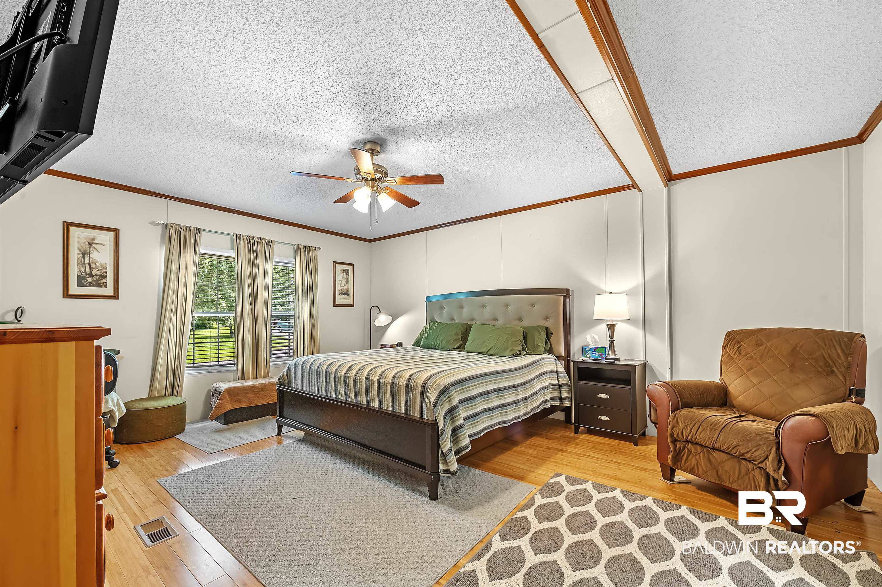 10970 Stucki Road Elberta, AL 36530 - Photo 25 of 56 Bedroom featuring Bamboo floors, ornamental molding, a textured ceiling, and ceiling fan