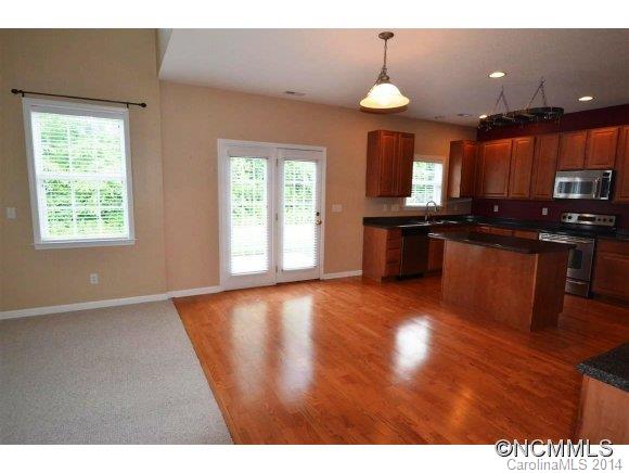 283 Wildbriar Road Fletcher, NC 28732 - Photo 5 of 13 a kitchen with stainless steel appliances granite countertop a stove a sink a window and wooden floor
