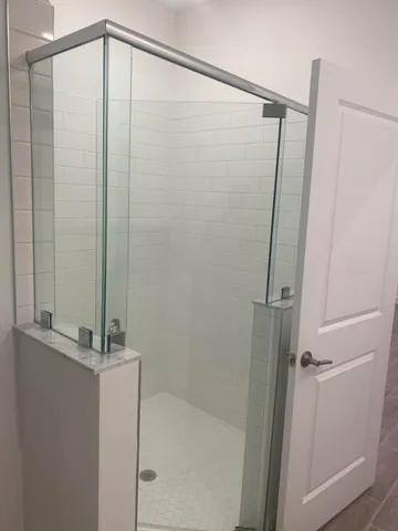 a white toilet sitting next to a shower