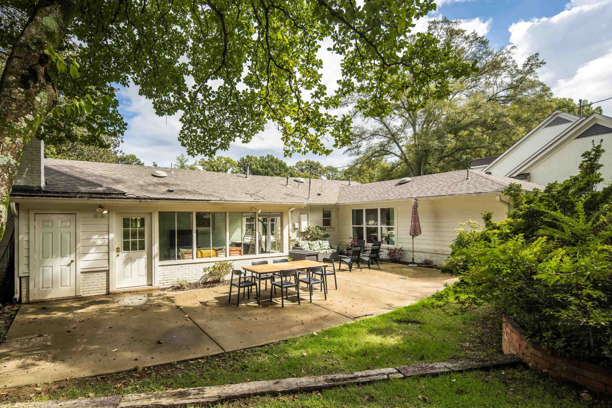 267 Barry Road Memphis, TN 38117 - Photo 34 of 40 a patio with a table and chairs and potted plants