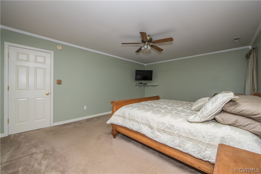5300 Takach Road Prince George, VA 23875 - Photo 17 of 35 a bedroom with a bed and a ceiling fan