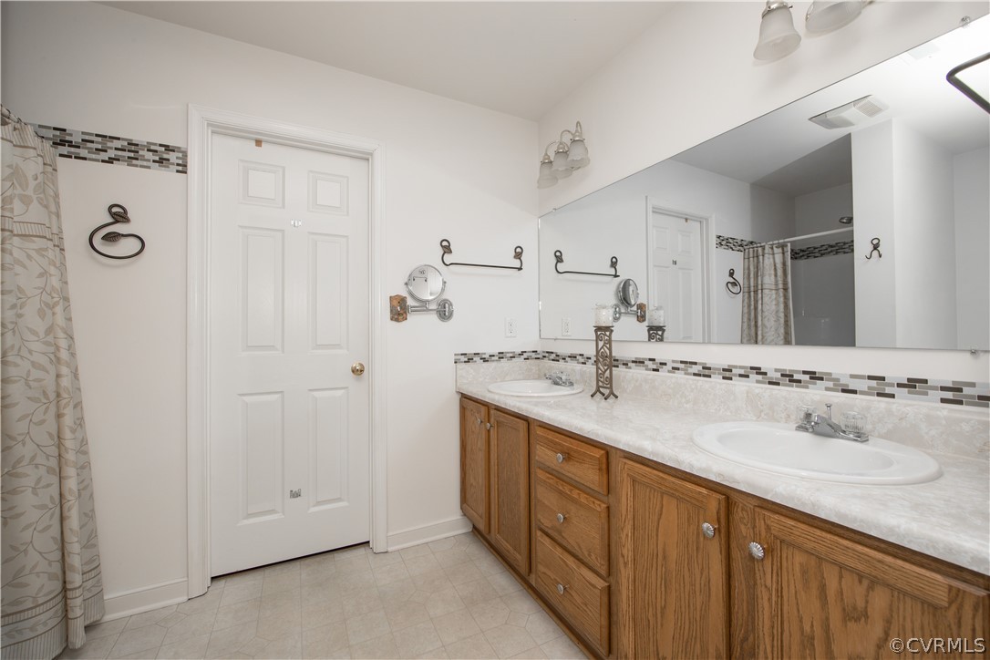 5300 Takach Road Prince George, VA 23875 - Photo 18 of 35 a bathroom with a double vanity sink mirror and double