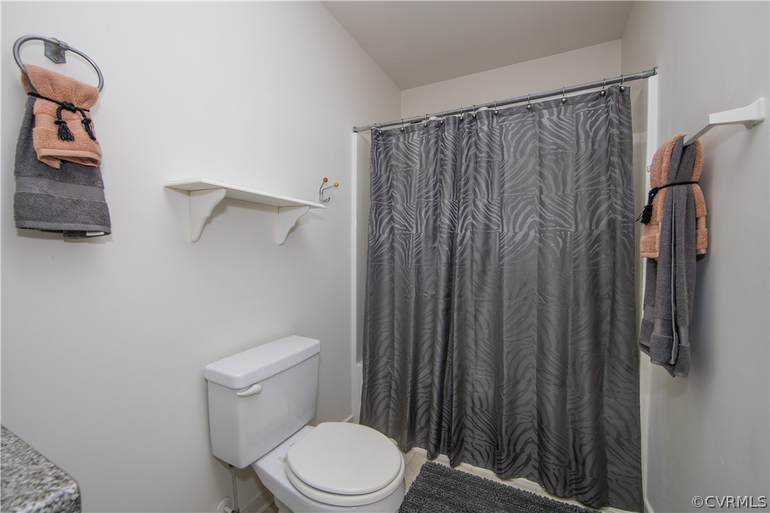 5300 Takach Road Prince George, VA 23875 - Photo 26 of 35 a white toilet sitting next to a shower curtain