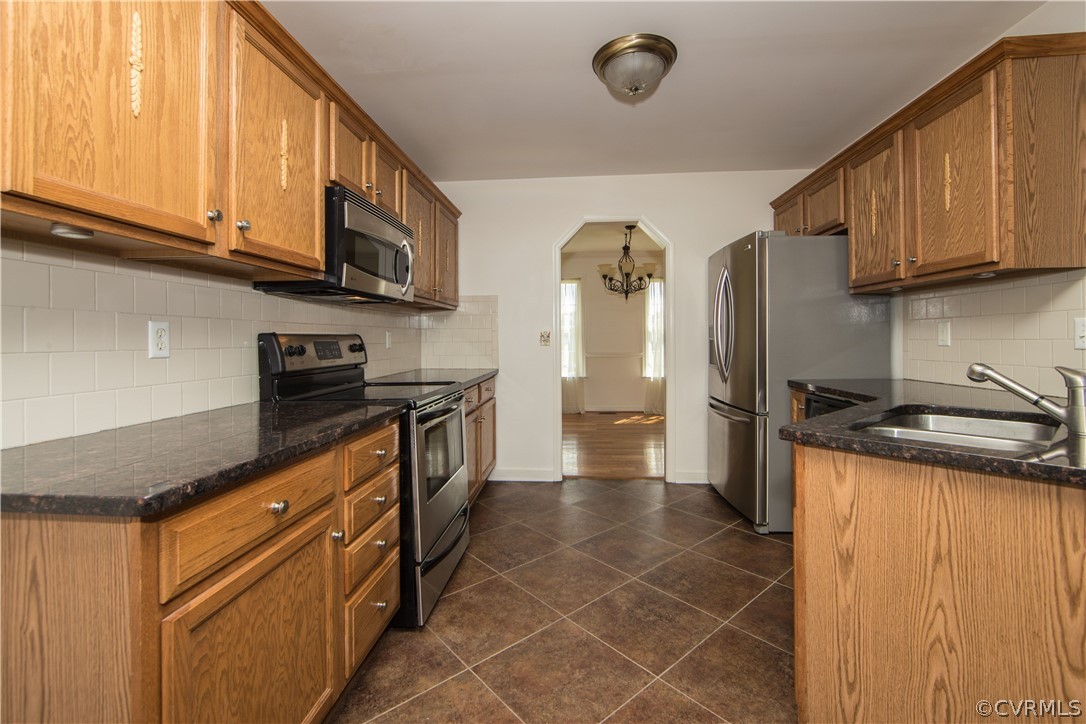5300 Takach Road Prince George, VA 23875 - Photo 6 of 35 a kitchen with stainless steel appliances granite countertop a stove a sink and a refrigerator