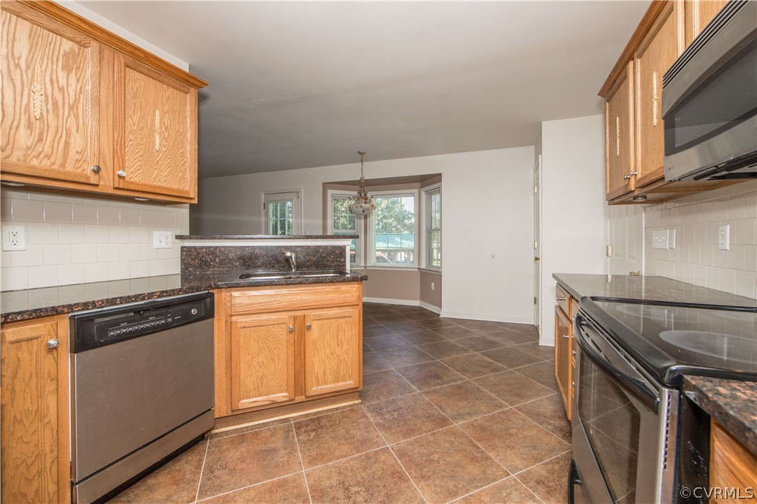 5300 Takach Road Prince George, VA 23875 - Photo 7 of 35 a kitchen with stainless steel appliances granite countertop a stove a sink and a microwave