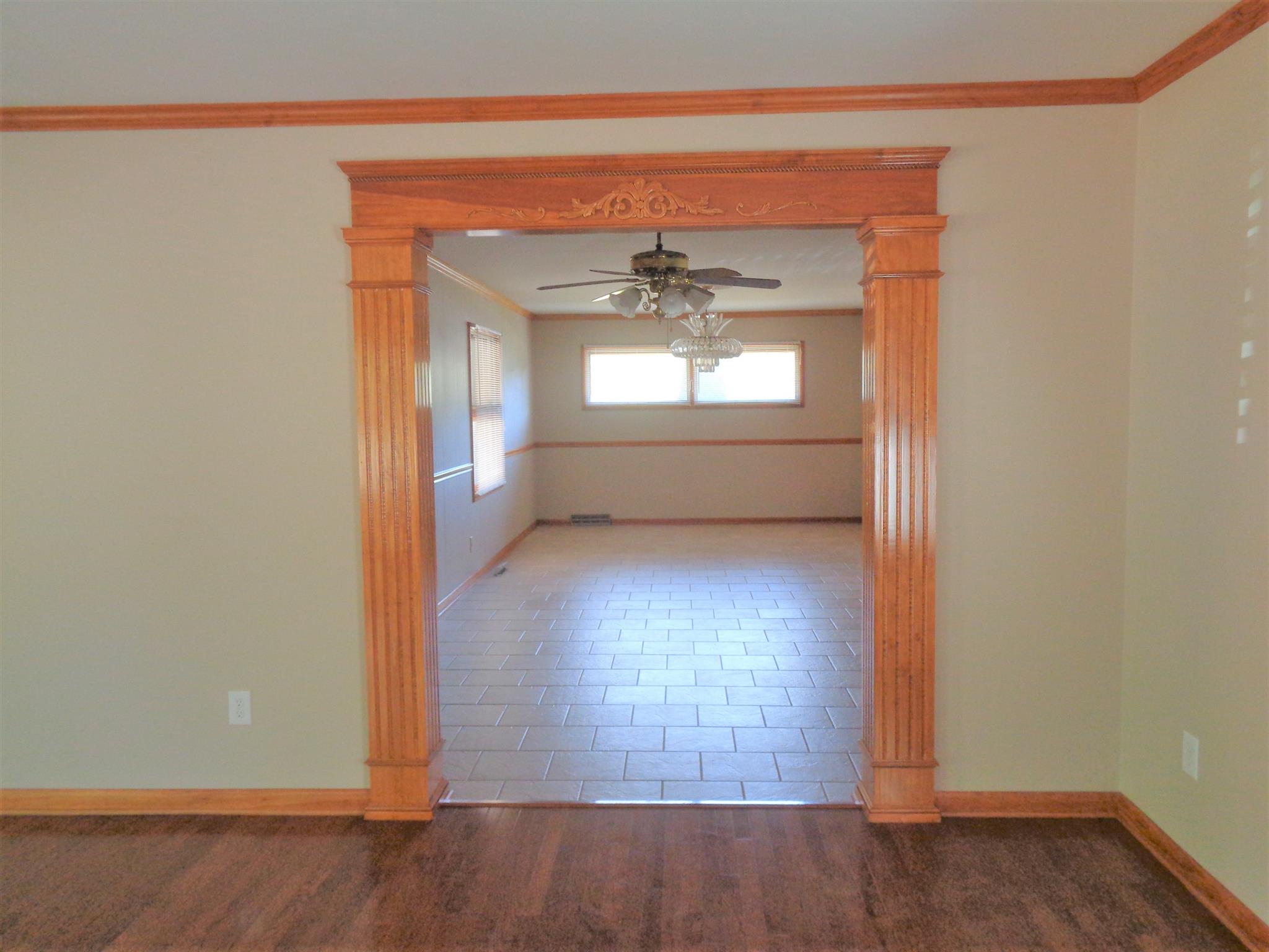 211 West Point Road Lawrenceburg, TN 38464 - Photo 5 of 25 a view of a hallway with wooden floor and a living room