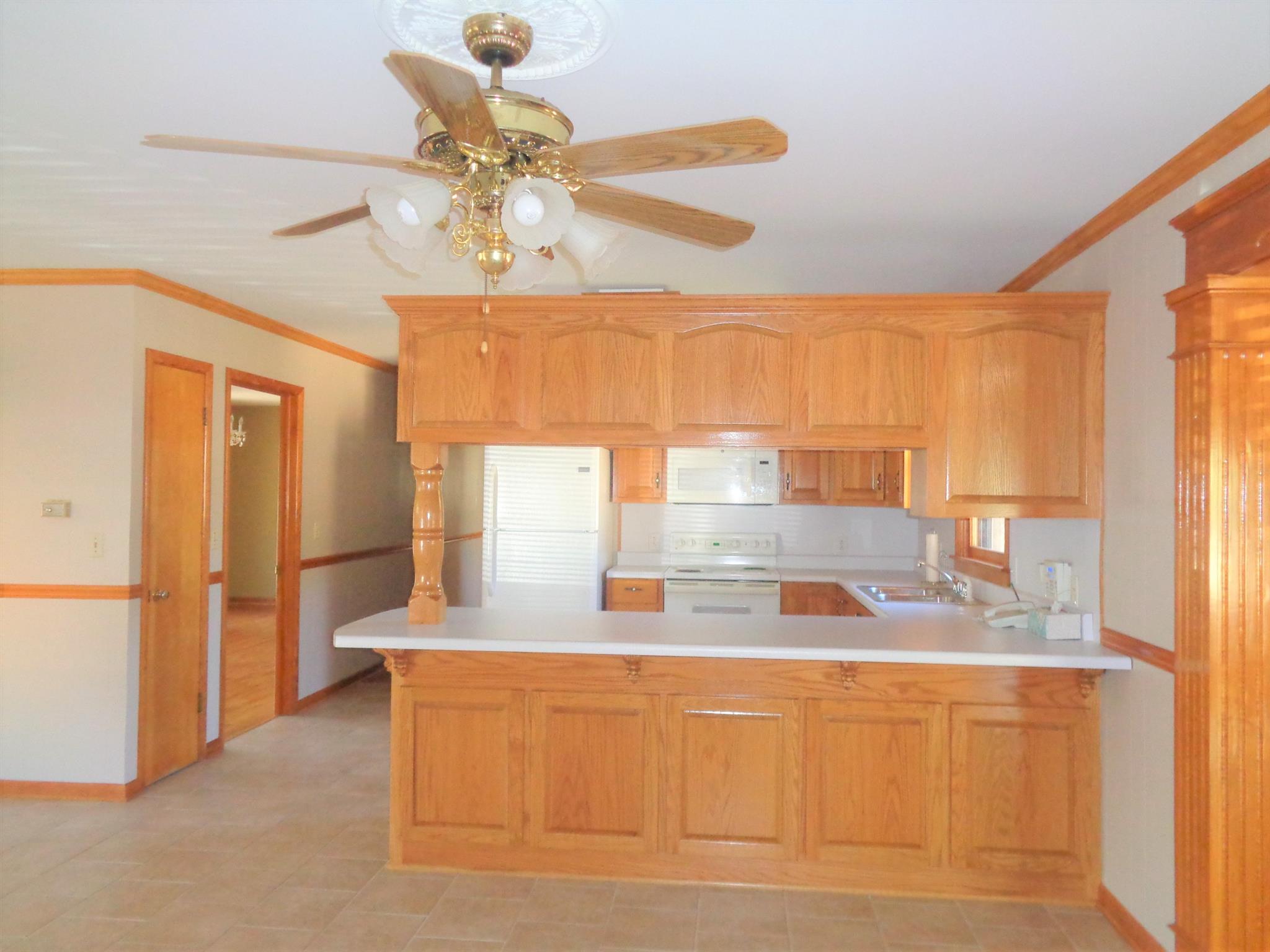 211 West Point Road Lawrenceburg, TN 38464 - Photo 7 of 25 a kitchen with stainless steel appliances granite countertop a sink and a refrigerator