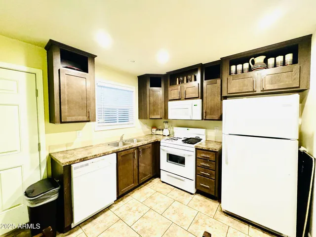 a kitchen with stainless steel appliances granite countertop a refrigerator and a stove