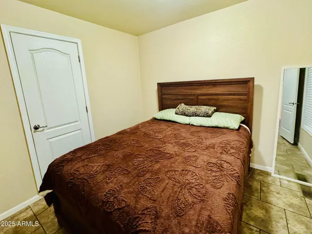 a bedroom with a bed and a mirror