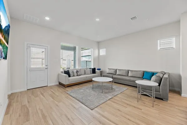 a living room with furniture and kitchen view