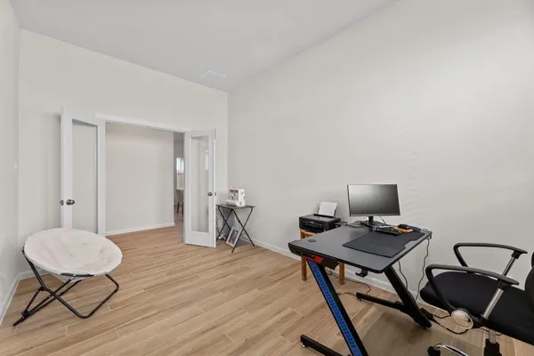 a bedroom with bed and wooden floor