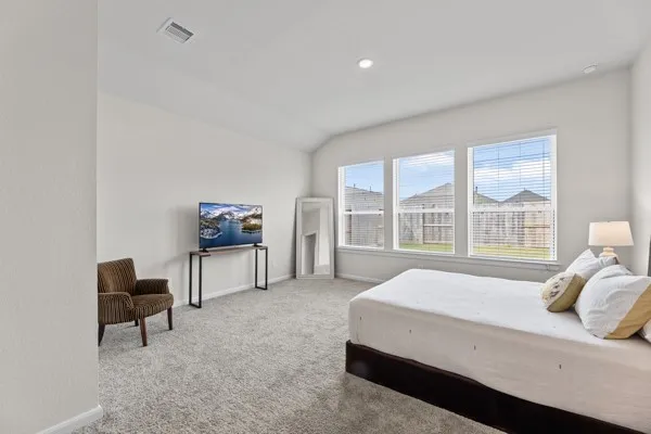 a bedroom with a bed and a desk