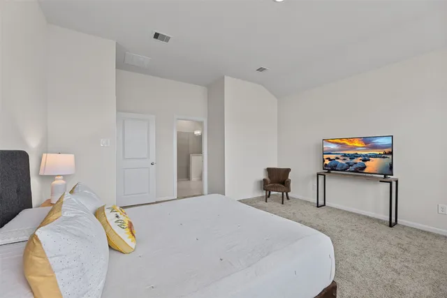 a bedroom with a bed and a chair