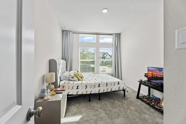 a bedroom with bed and a window