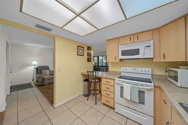 a spacious bedroom with a bed and ceiling fan