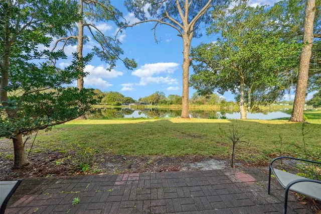 an aerial view of a house with a garden and lake view